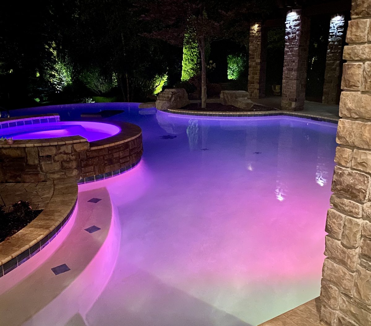 Spillover spa with stone coping and LED lighting